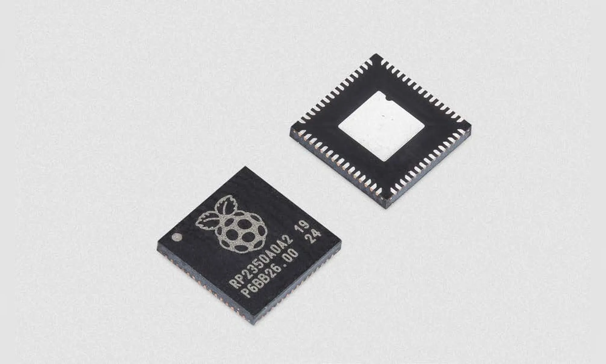 Two Raspberry Pi RP2350 microcontroller packages, shown from the top and underside.